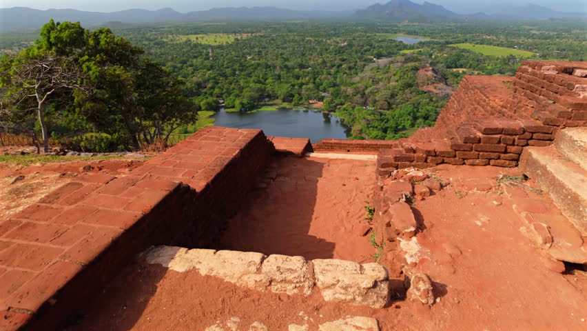Ancient Brick Ruins Of Sigiriya Lion Rock In Sri Lanka, Overlooking Lush Green Forest And Calm Lake. high angle, POV shot