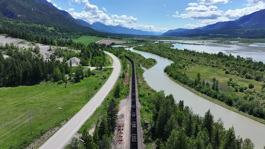 Aerial tracking of a cargo train traveling between Colombia River and Hwy 95 - British Colombia - Canada