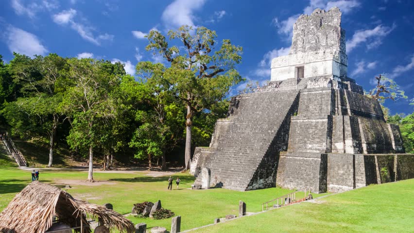 Mayan Temple I (Gran Jaguar) at Tikal National Park - GuatemalaExplore the ancient Mayan ruins of Tikal under the vibrant sky in Guatemala, showcasing the Temple I pyramid surrounded by lush greeneryTikal, the ruin of an ancient city, which was likely to have been called Yax Mutal, found in a rainforest in Guatemala.