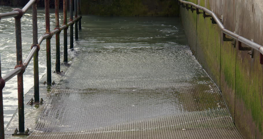 Mid shot of Incoming tide flooding the ramp to the beach at Shoreham harbour
