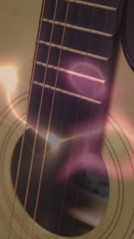 Animation of white, blue and pink light trails over acoustic guitar on smokey background. Music, creativity, performance and entertainment concept digitally generated video.