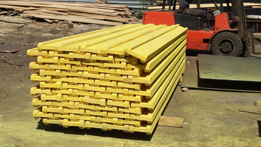 Wooden covering stack painted yellow for construction sites at sawmill factory
