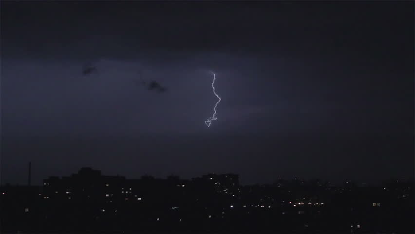 Thunder and lightning above city sky. Lightning forks to buildings, sound