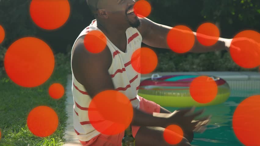 Man reaching for tossed ball, falling in pool for marketing, orange circles obscuring. Backyard, outdoor, float, donut, inflatable, sunglasses, friends
