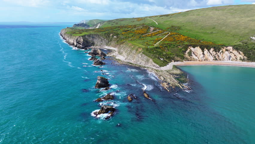 Aerial shot flying over rocky coastline near Lulworth Cove, Dorset