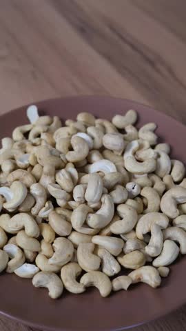 Cashew nuts filling a brown bowl, representing a vegan, organic, and nutritious food