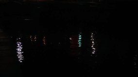 Night Water Reflections Of City Lights, Vertical Color Streaks Shimmer On Rippling Water Surface, Slow Motion Ripple Creates Elongated Neon Trails, Ambient Glow Suggests Quiet Urban - Powered by Shutterstock - Get 15% off with code: PIKWIZARD15