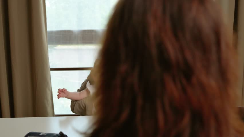 Mother holding baby girl during consultation with pediatrician
