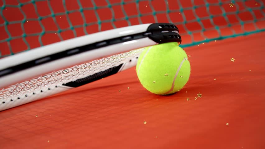 Racket lifting and revealing yellow tennis ball rolling toward green net with gold stars for sports. Closeup, macro, sphere, court, surface, texture, focus