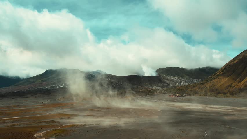 Drone overview of massive white plume rising from Mount Bromo crater, East Java, Indonesia