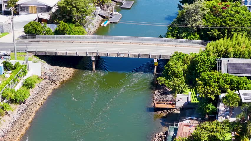 Aerial view of traffic crossing urban bridge over water.