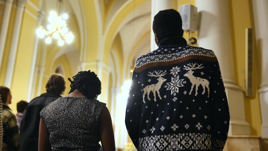 Congregation of diverse people attending a Catholic Church mass service