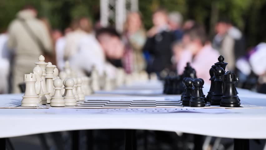 Chess game on board with white and black pieces ready for outdoor tournament