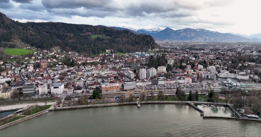 Aerial view of Bregenz cityscape, where buildings meet water against a backdrop of mountains, capturing the blend of urban and natural elements, Bregenz, Austria.