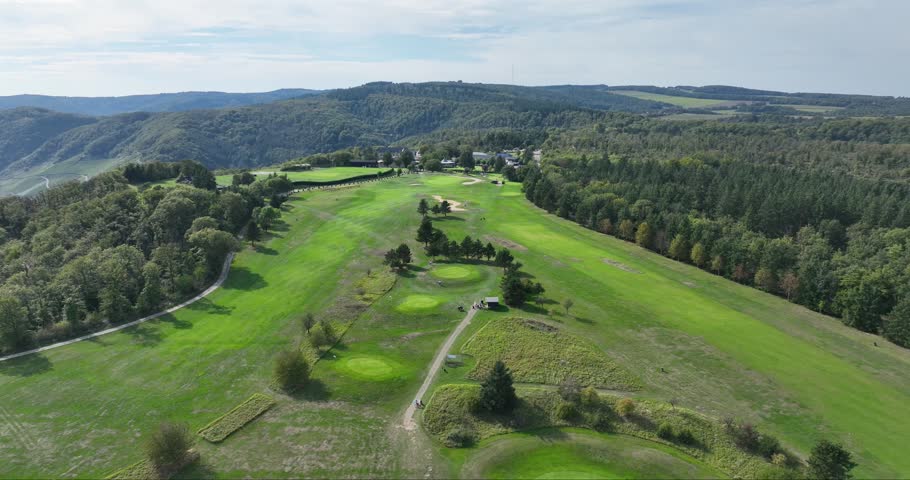 Aerial view of the lush, green Golfclub Jakobsberg, a verdant oasis nestled among the rolling hills and the river, Braubach, Germany.