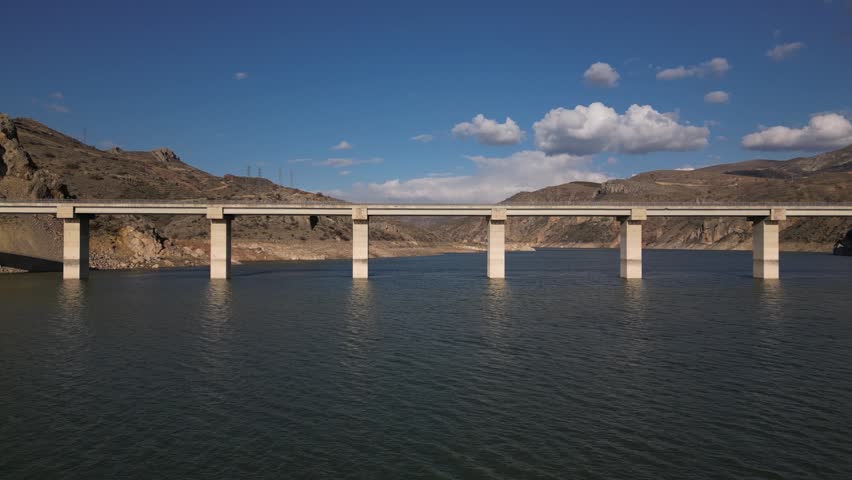 Aerial Footage of Highway Bridge Over Green Water