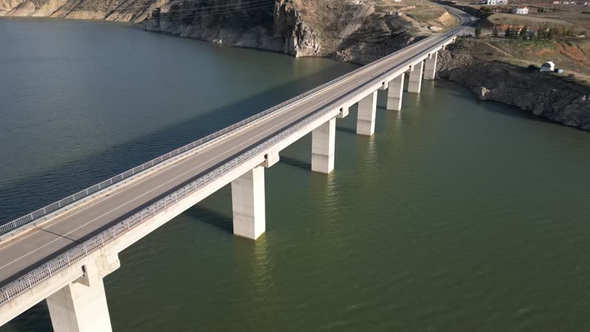 Aerial Footage of Highway Bridge Over Green Water