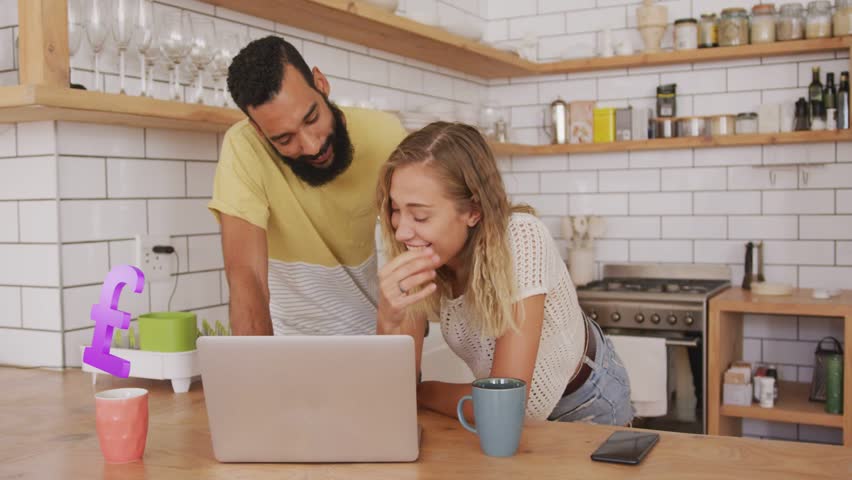 Man and woman leaning into laptop in kitchen checking money, sparking symbols filling then fading. Couple, home, finance, currency, screen, collaboration, minimalist