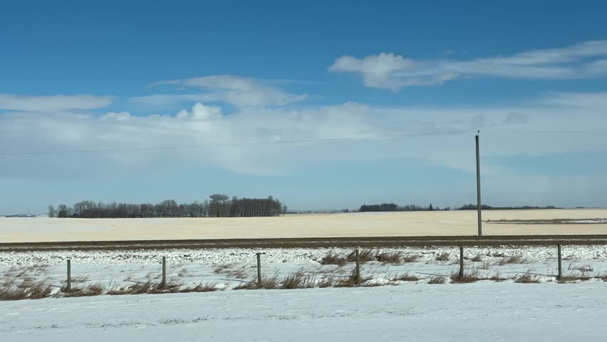 Farm and fields in the winter sunny day passing by, Canada