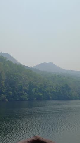 A landscape of forests shrouded in mist on mountaintops.