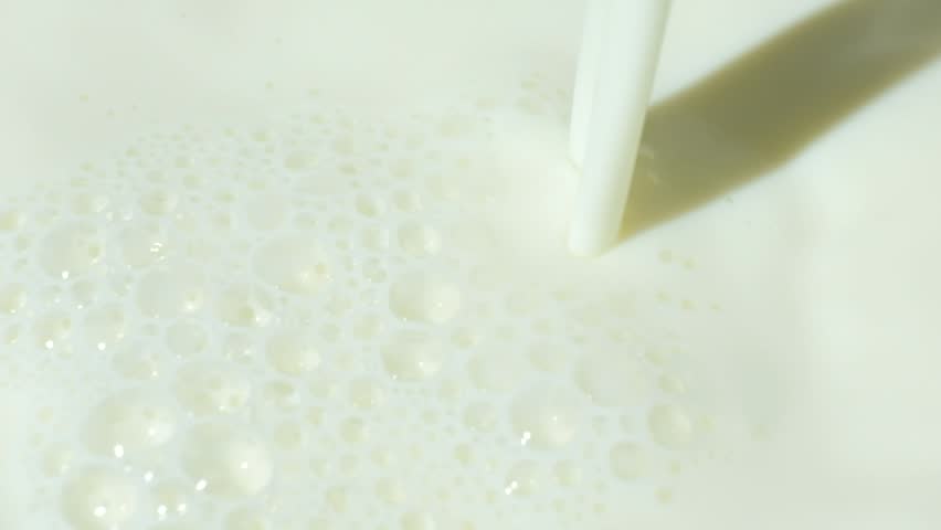 Cinematic Slow Motion Flow of Fresh White Milk Close Up