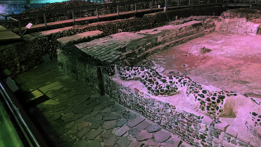 Interior view of the Templo Mayor archaeological ruins in the historic center of Mexico City. Illuminated ancient stone structures of the Aztec Empire near Plaza de la Constitución