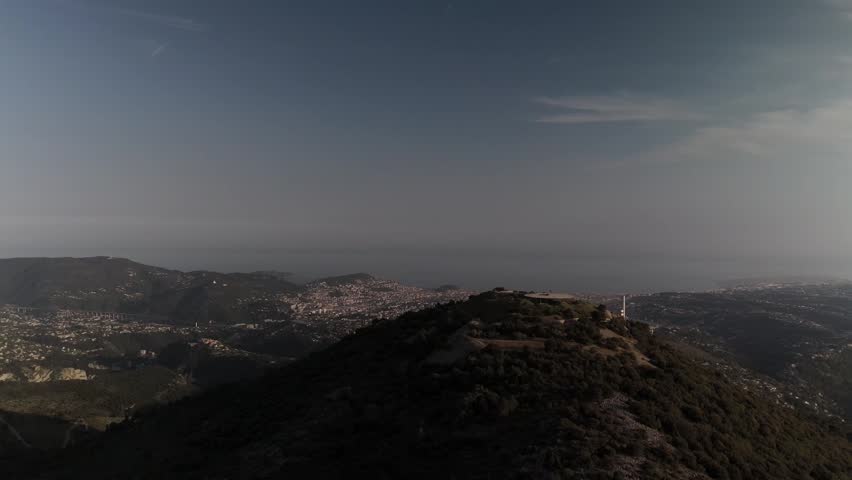 A view of a mountain and a city from the top.