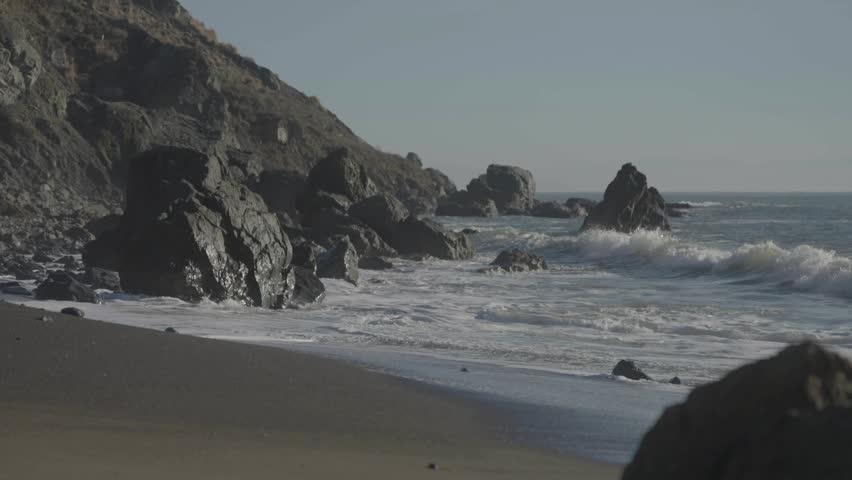 Beach with rocks and hill background, San Francisco