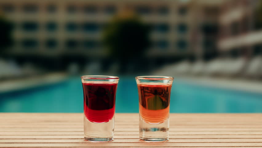 Pouring shot of red bitter, Cognac, whisky, Campari, Aperol, Cherry Vermouth Negroni, spanish wine drink, Alcoholic Americano Cocktail bitter, sweet vermouth and soda water, close up of making drink