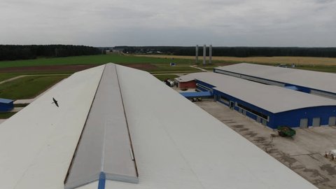 Aerial Flight over Agricultural Complex Rooftops