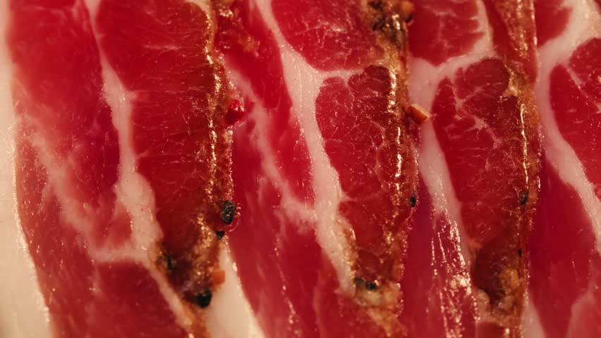  Sliced ham jamon fat bacon meat, beef pastrami thick pieces on a wooden board, beef or pork jamon. Chef cooking breakfast, smoked bacon in cafe. 
