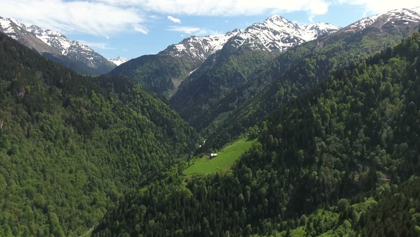 Alpine chalet Alps lush meadow beneath mountains fairytale retreat highland weather detail. Charming cabin rests beside forested valley peaceful upland dwelling pastoral escape. The view adds strong search relevance for geography, environment, scenic travel, and natural landscape storytelling with clear terrain definition.