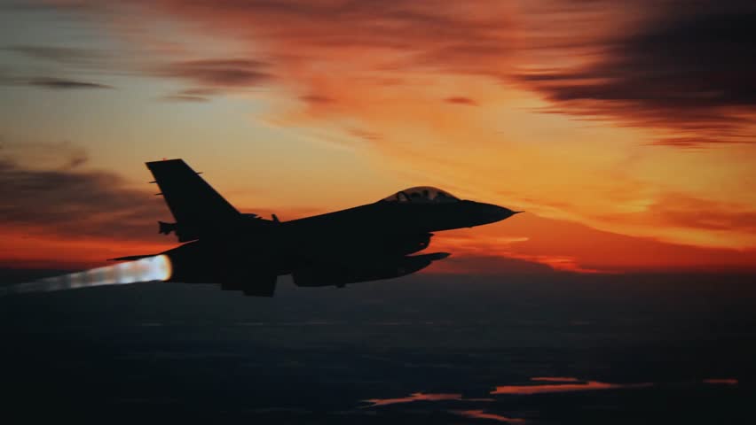 Cinematic 4k silhouette of a F-16 fighter jet flying at high speed through a dramatic sunset sky, featuring an afterburner flame trail, perfect for military aviation and defense projects.