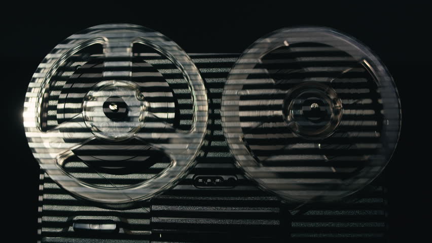 Tape audio music player, VHS studio magnetic tape, vintage retro spool reel to reel player and recorder, magnetic tape data storage close up, music studio. 