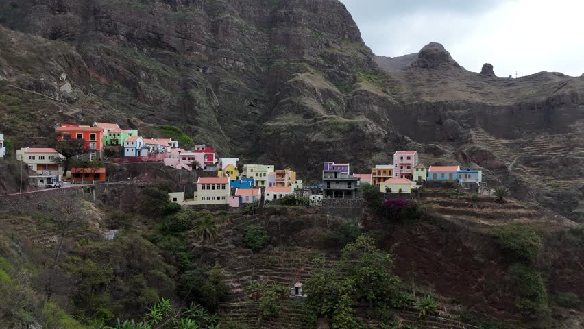 drone view of Iconic colorful houses in a deep volcanic valley Fontainhas village perched on cliffs in Santo Antao, Cape Verde aerial footage