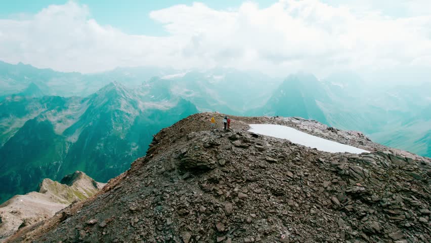 Dramatic Rocky Alpine Mountain Peak with Turquoise Lake at its Base