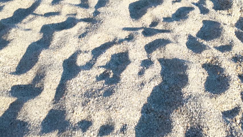 Sandy beach with many footprints in the sand