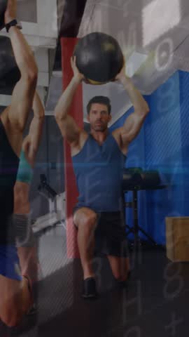 On cue two men leading med-ball overhead lunges, alternating, graphics sweeping for group training. Medicine, ball, synchronization, gym, fitness, class, vertical video