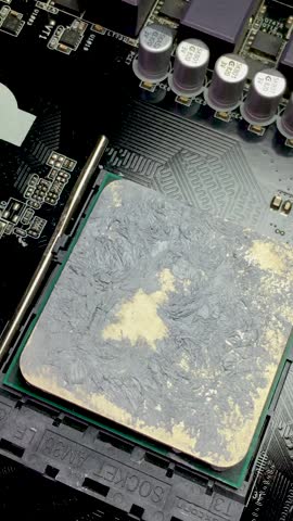 Part of a computer motherboard with a processor close-up. Vertical video.