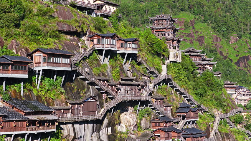 Ancient village and traditional wooden buildings built on the cliffs at the famous Wangxiang Valley Scenic Area in Jiangxi, China