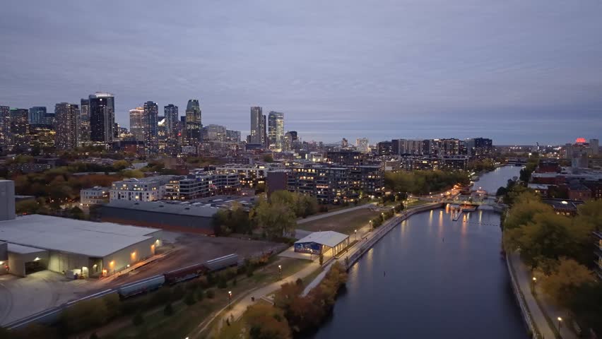 Aerial night skyline of Montreal with Lachine Canal, illuminated bridge, downtown skyscrapers and city lights in Quebec, Canada. g.