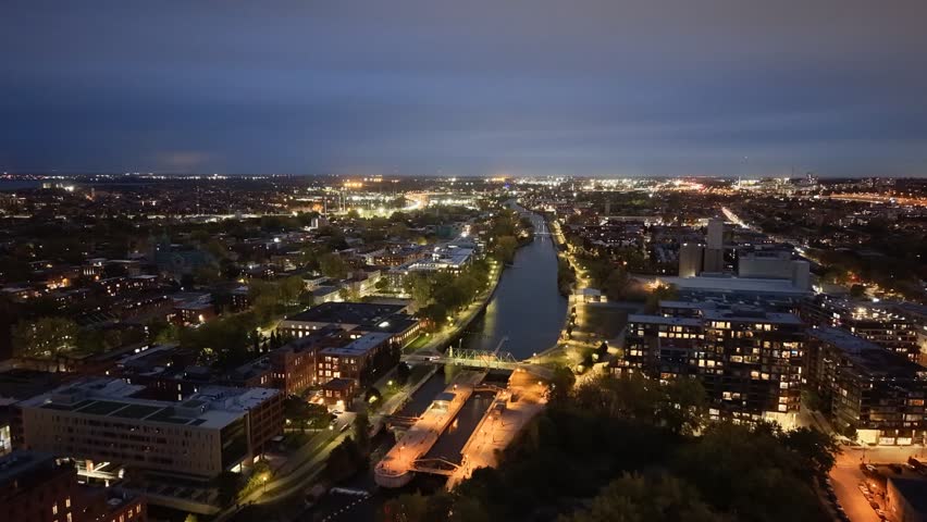 Aerial night skyline of Montreal with Lachine Canal, illuminated bridge, downtown skyscrapers and city lights in Quebec, Canada. g.