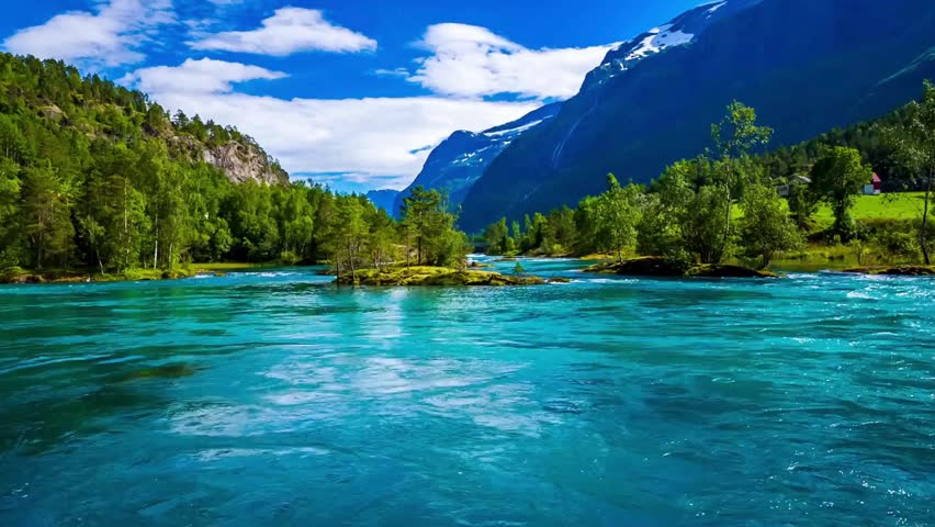 Scenic view of a river flowing through a mountainous landscape with trees