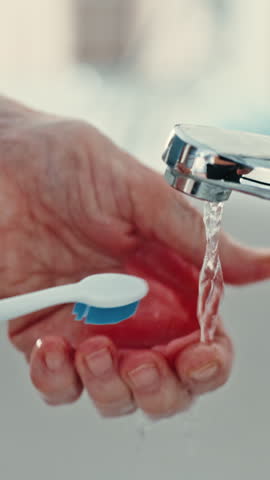 Toothbrush, water or senior hands with denture in bathroom, oral hygiene or morning routine for wellness. Dental care, bacteria removal or old person by sink to clean fake teeth, fresh breath or home
