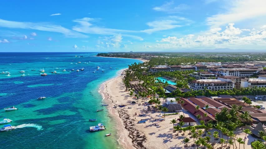 Tropical resort hotels with beaches on the Atlantic Ocean coast. Summer landscape of tropical palm beach from a bird