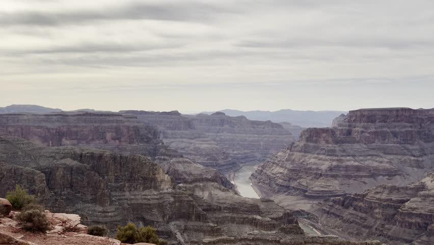 Scenic panoramic view of the Grand Canyon West Rim in Arizona, USA. Desert landscape with layered red rock cliffs, deep canyon formations, Colorado River view. A road trip near Eagle and Guano Point