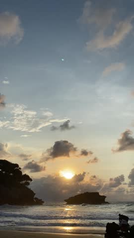 Beach sunrise, hills, with happy family enjoying the beach