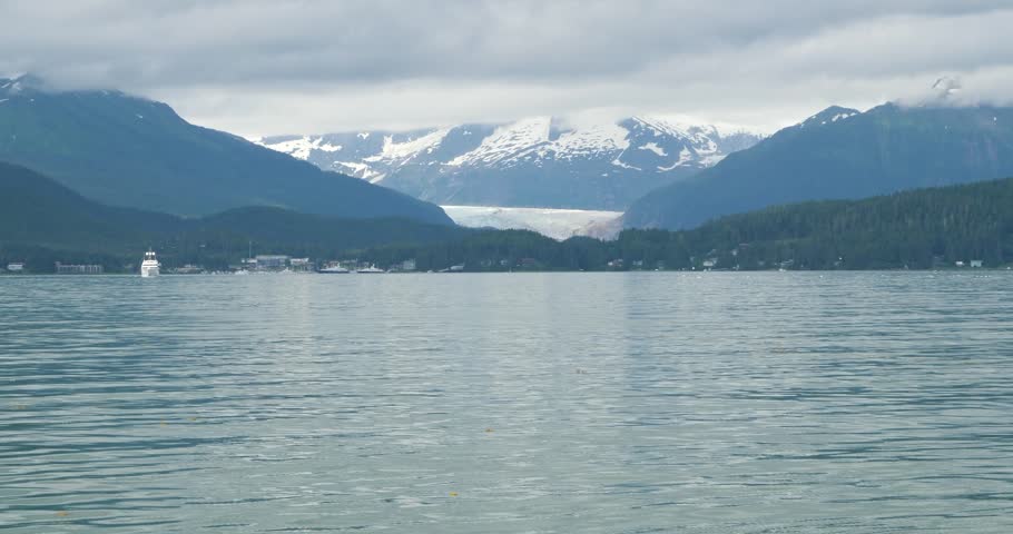Beautiful landscape with Mendenhall Glacier and the surrounding mountains covered by clouds, Alaska.