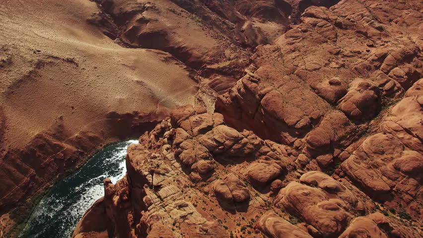 Stunning aerial view of the Colorado River flowing through a magnificent red rock canyon in Arizona