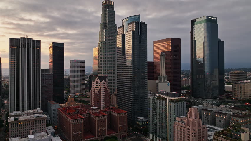 Air view over downtown Los Angeles. Los Angeles skyscrapers from sky. Flying above LA cityscape. Aerial view of downtown LA. Urban LA from drone angle. Los Angeles skyline wide aerial.